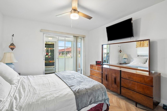 bedroom with access to outside, light parquet flooring, and ceiling fan