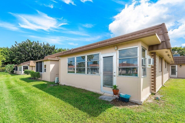 view of side of property with a lawn