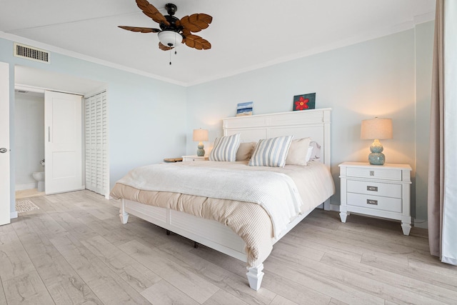 bedroom featuring ceiling fan, light hardwood / wood-style flooring, ensuite bath, and crown molding