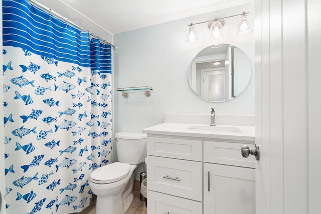 bathroom featuring toilet, a shower with shower curtain, and vanity