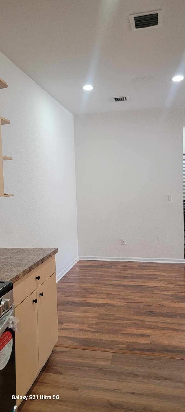 3569 Forest Hill Blvd Unit 103, Palm Springs, FL 33406 - empty room featuring baseboards, visible vents, dark wood-type flooring, and recessed lighting