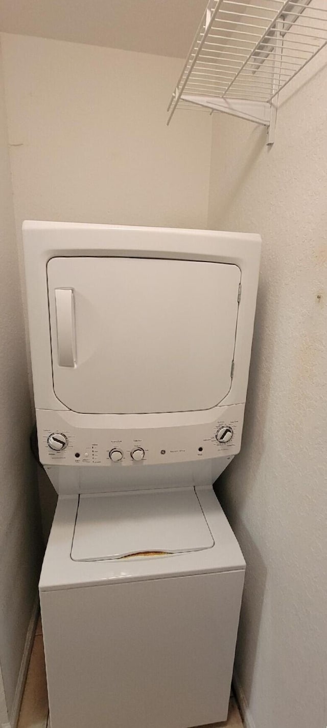 laundry room with stacked washer / drying machine