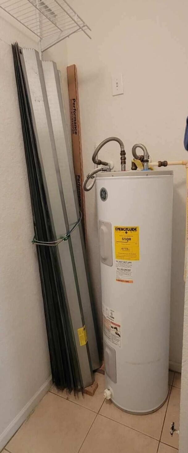 utility room featuring water heater