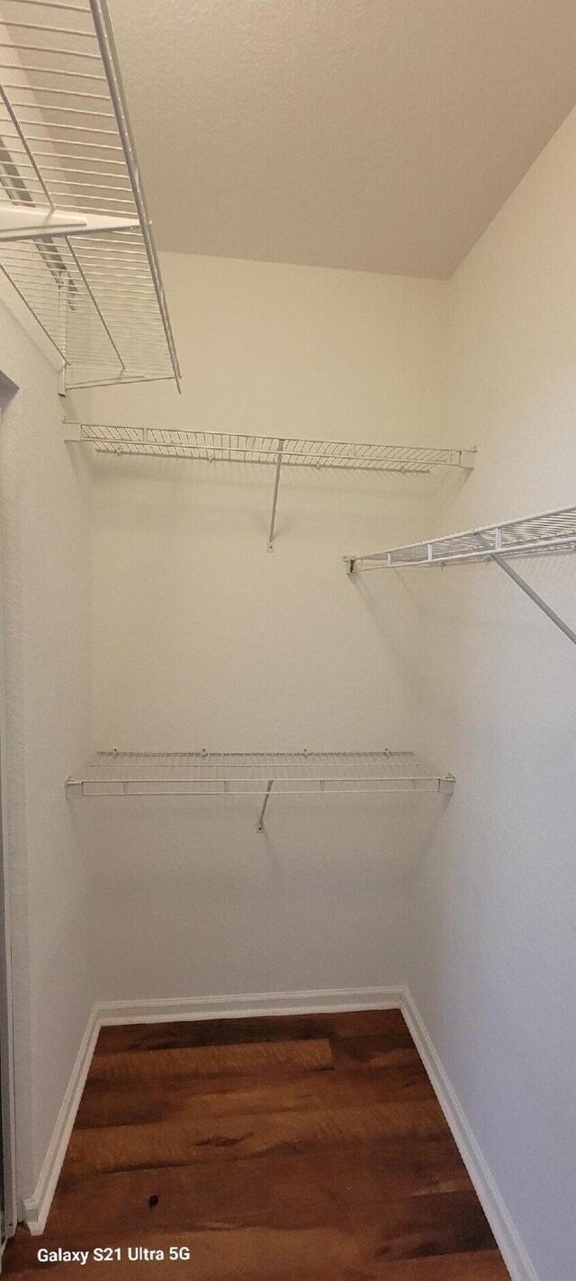 3569 Forest Hill Blvd Unit 103, Palm Springs, FL 33406 - walk in closet with dark wood finished floors