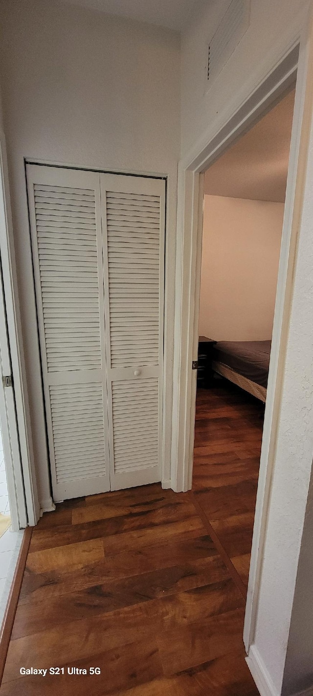 hallway featuring dark hardwood / wood-style flooring