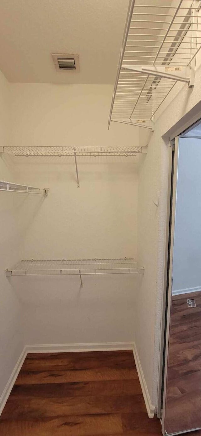 3569 Forest Hill Blvd Unit 103, Palm Springs, FL 33406 - walk in closet featuring visible vents and wood finished floors