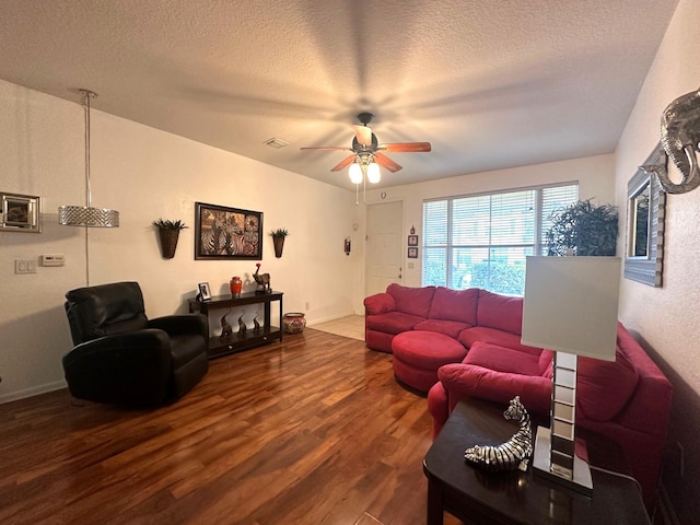 living room with hardwood / wood-style floors, a textured ceiling, and ceiling fan