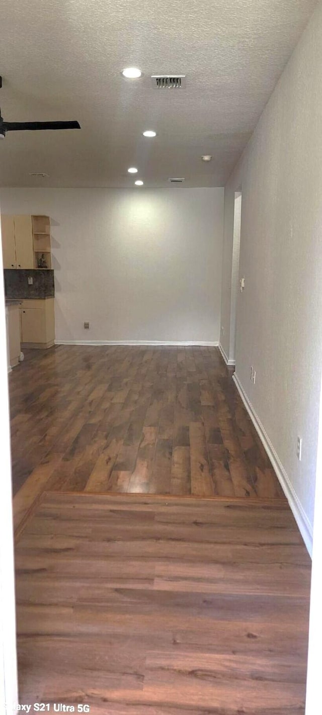 3569 Forest Hill Blvd Unit 103, Palm Springs, FL 33406 - unfurnished room featuring a textured ceiling, visible vents, wood finished floors, and baseboards