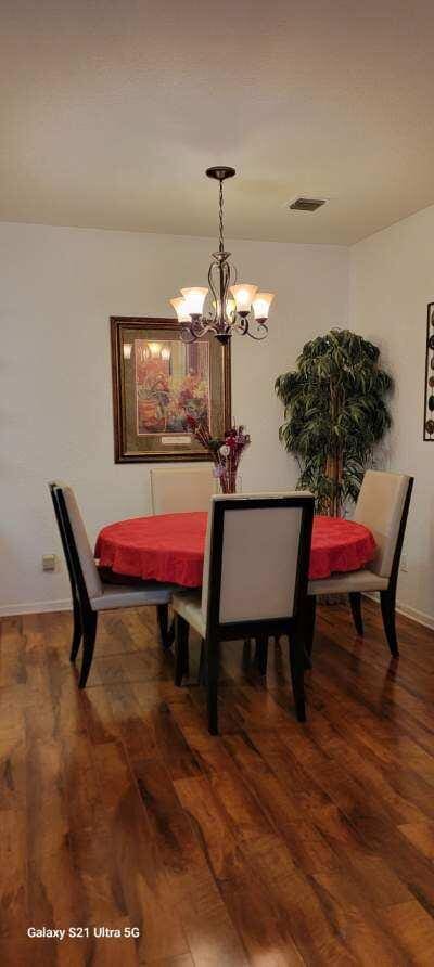 dining room featuring a notable chandelier and dark hardwood / wood-style floors