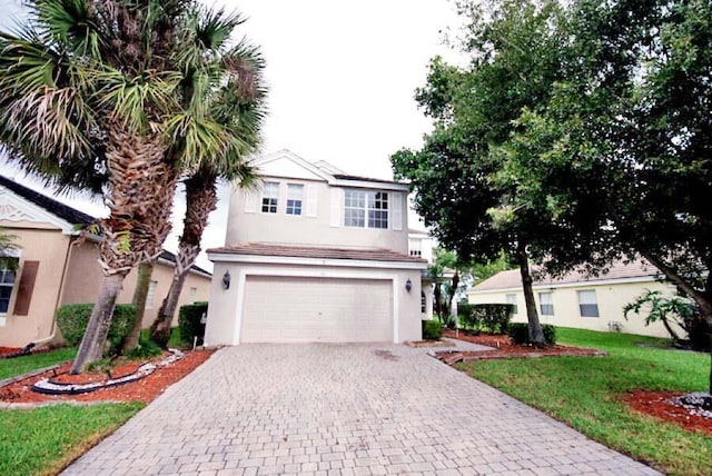 view of front of home with a garage and a front yard