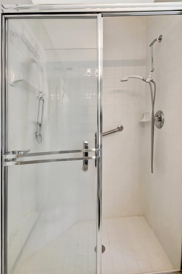 bathroom with a shower with shower door