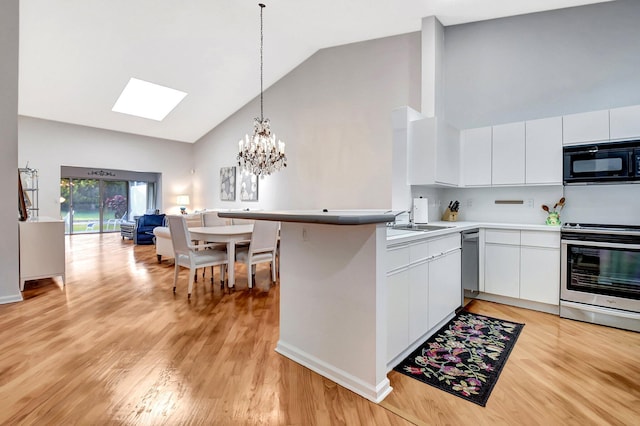 kitchen featuring stainless steel range with electric stovetop, light wood-type flooring, kitchen peninsula, pendant lighting, and white cabinets