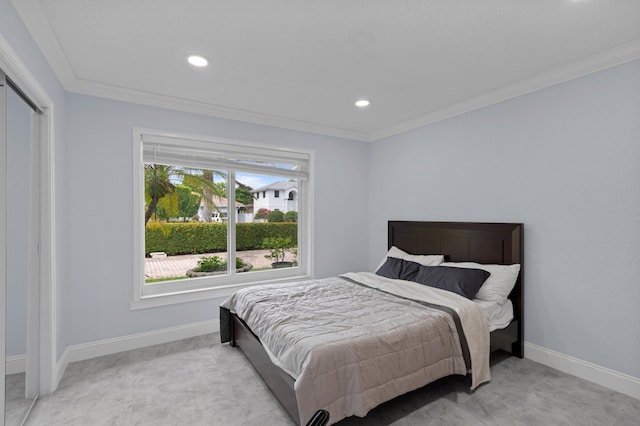 bedroom featuring multiple windows, ornamental molding, and a closet