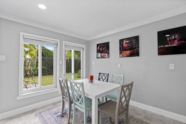 dining space featuring crown molding