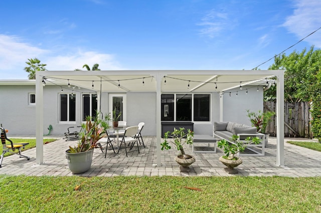 rear view of house featuring an outdoor living space and a patio