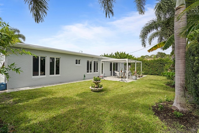 back of house with a yard and a patio area