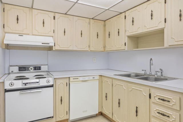 kitchen featuring sink, white appliances, and a paneled ceiling