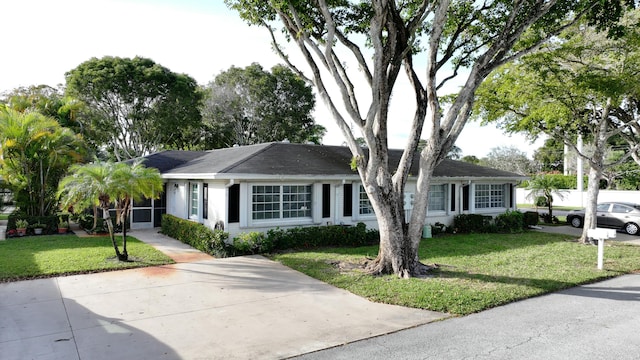 ranch-style home featuring a front yard