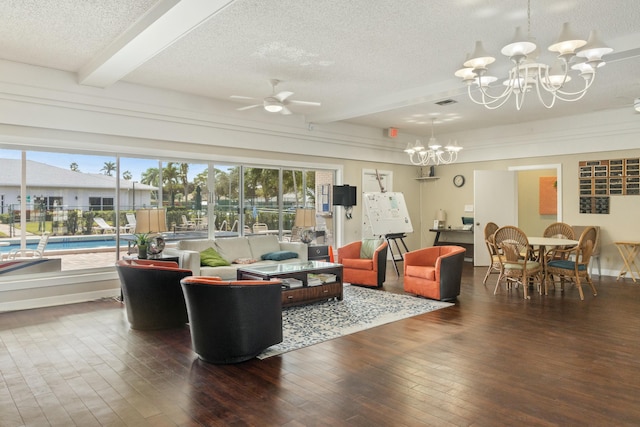 living room featuring ceiling fan with notable chandelier, beamed ceiling, dark wood-type flooring, and a textured ceiling