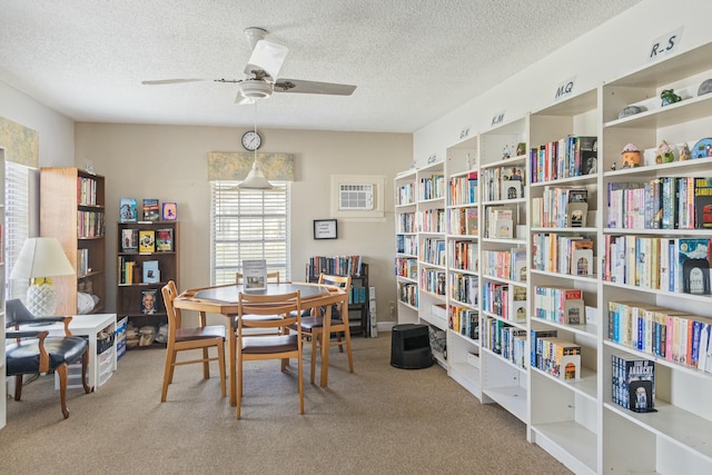 carpeted dining room with ceiling fan and a textured ceiling