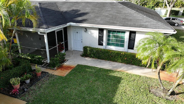 exterior space with a front yard and a sunroom