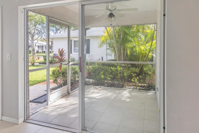 doorway to outside featuring ceiling fan and light tile patterned floors