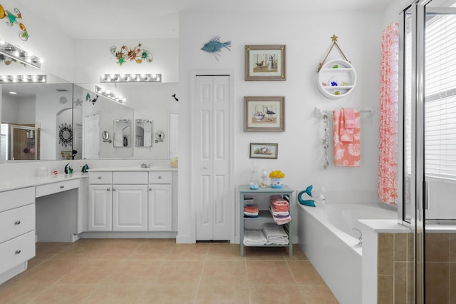 bathroom featuring independent shower and bath, vanity, and tile patterned floors