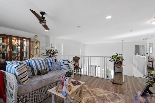 living room featuring ceiling fan and wood-type flooring