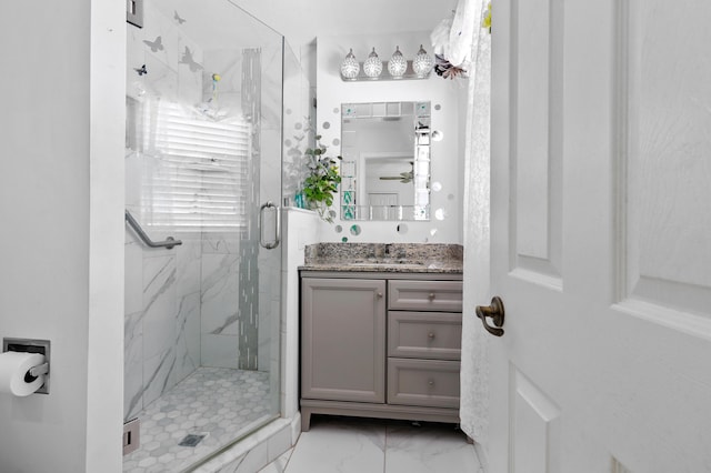 bathroom featuring vanity and a shower with door