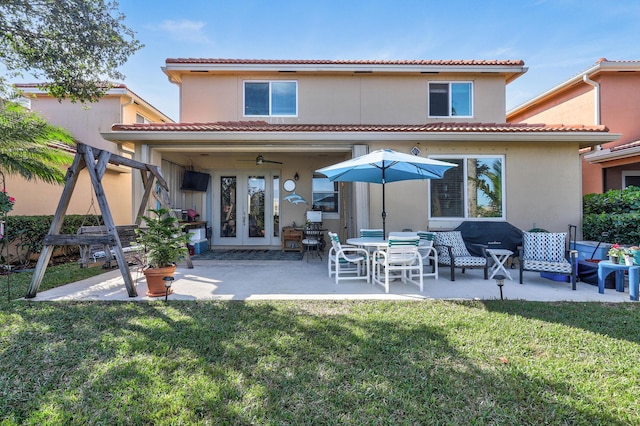 back of house featuring a yard, a patio area, french doors, and ceiling fan