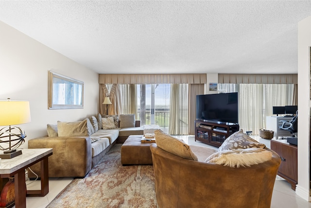 tiled living room featuring a textured ceiling