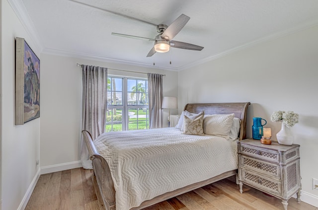 bedroom with ornamental molding, ceiling fan, and light hardwood / wood-style floors