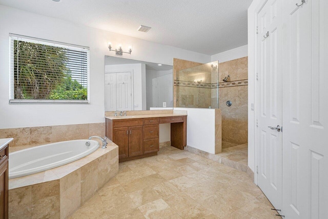 bathroom featuring separate shower and tub and vanity