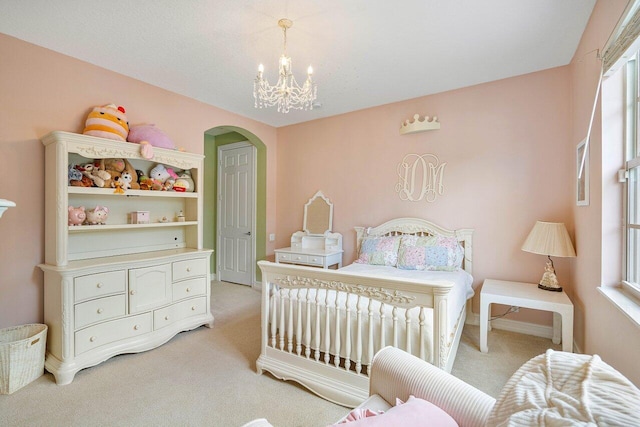 bedroom with multiple windows, light carpet, and a notable chandelier