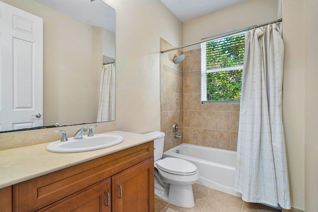 full bathroom featuring toilet, vanity, tile patterned floors, and shower / bath combo with shower curtain