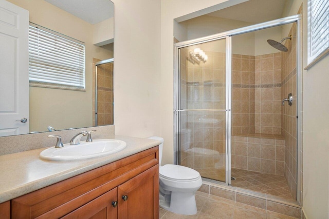 bathroom with toilet, tile patterned flooring, walk in shower, and vanity