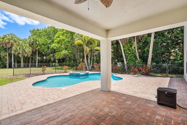 view of swimming pool with ceiling fan, a patio area, and an in ground hot tub