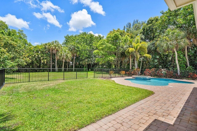 view of pool with an in ground hot tub, a lawn, and a patio