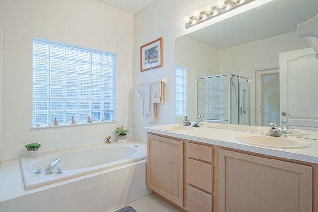 bathroom featuring tile patterned floors, separate shower and tub, and vanity