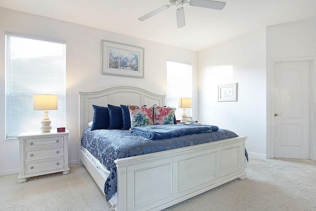 bedroom with light carpet, ceiling fan, and vaulted ceiling