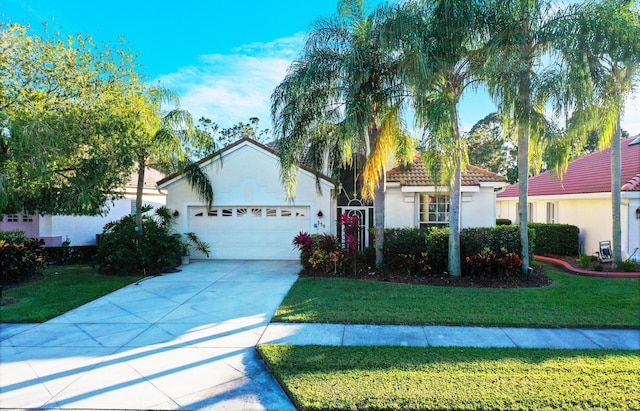 view of front of home featuring a front lawn and a garage