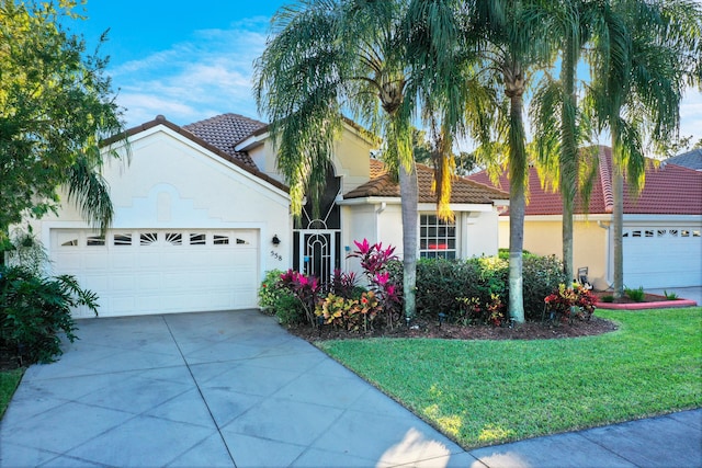 view of front of property featuring a front yard and a garage