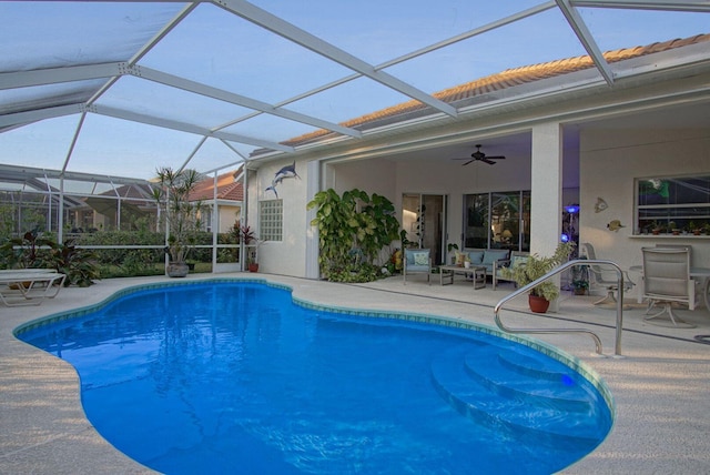 view of swimming pool featuring ceiling fan, a patio area, and glass enclosure