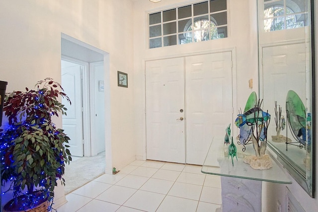 entrance foyer with carpet flooring and a high ceiling