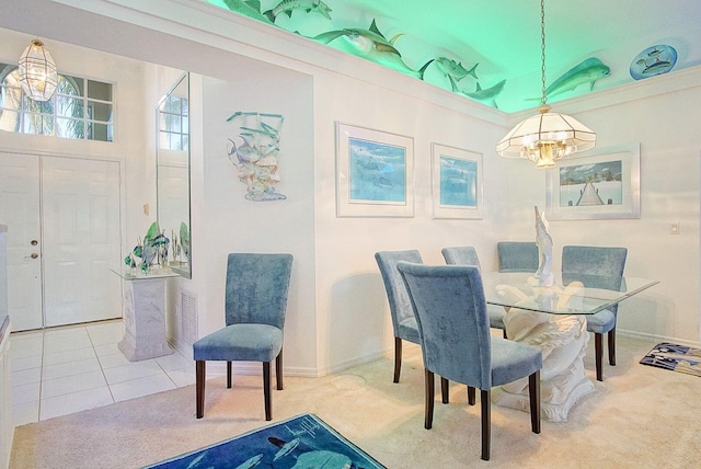 carpeted dining area with an inviting chandelier and ornamental molding