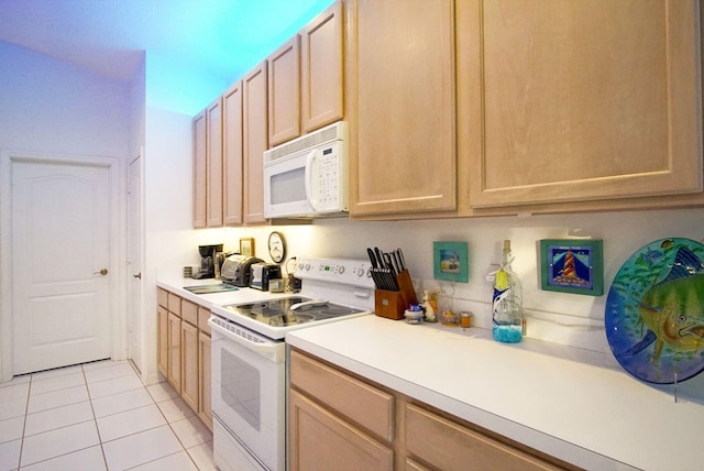 kitchen with light tile patterned floors, light brown cabinetry, and white appliances