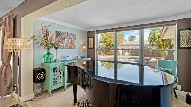 dining area with a wealth of natural light, ornamental molding, and a textured ceiling