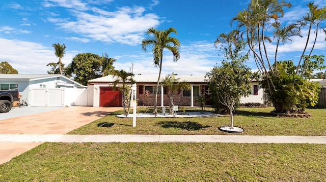 single story home featuring a garage and a front lawn