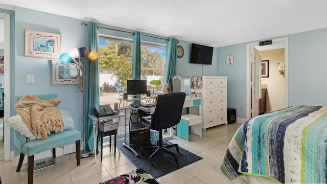 bedroom with light tile patterned floors and ensuite bath