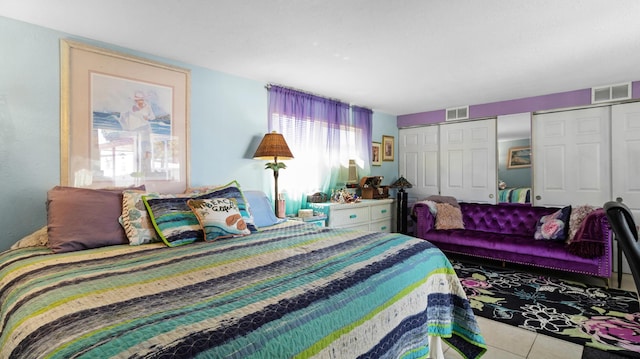 tiled bedroom with multiple closets